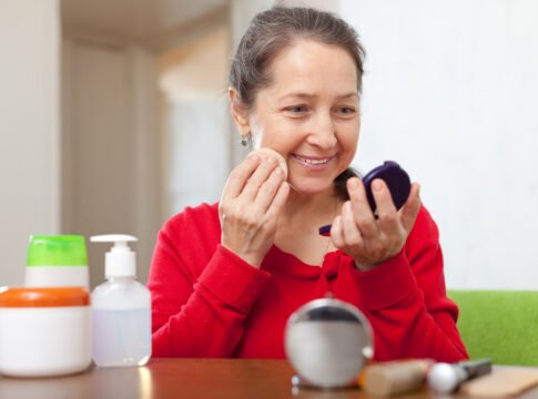 mature woman puts facepowder Wrong Skincare Order Wastes Money